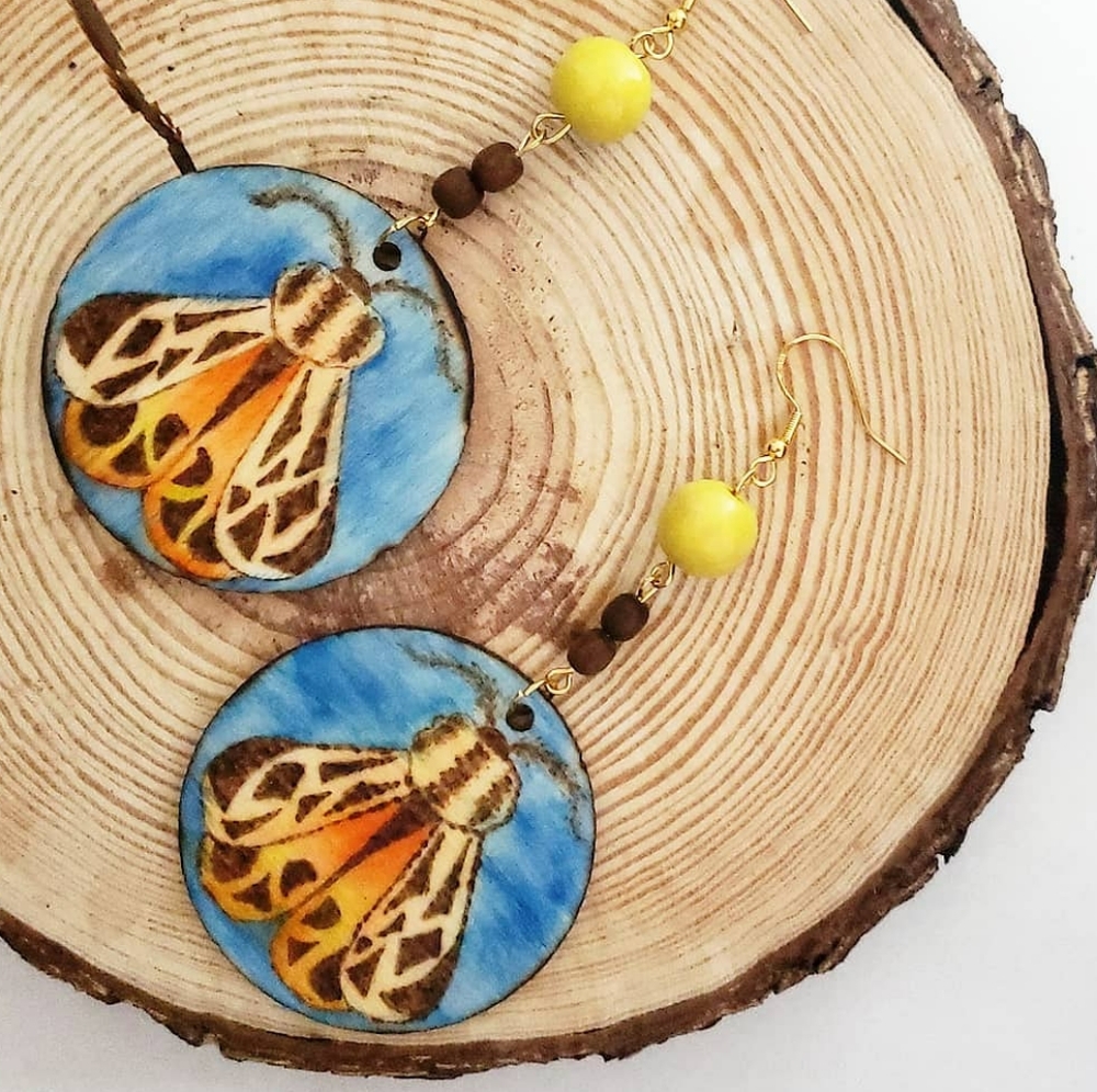 Hand wood burned tiger moth earrings on wood slices